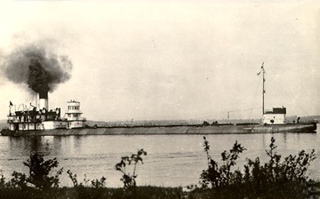 Starboard side view, fully loaded, in the St. Mary's River (between Lake Superior and Lake Huron). Note detached pilothouse, c.1905.